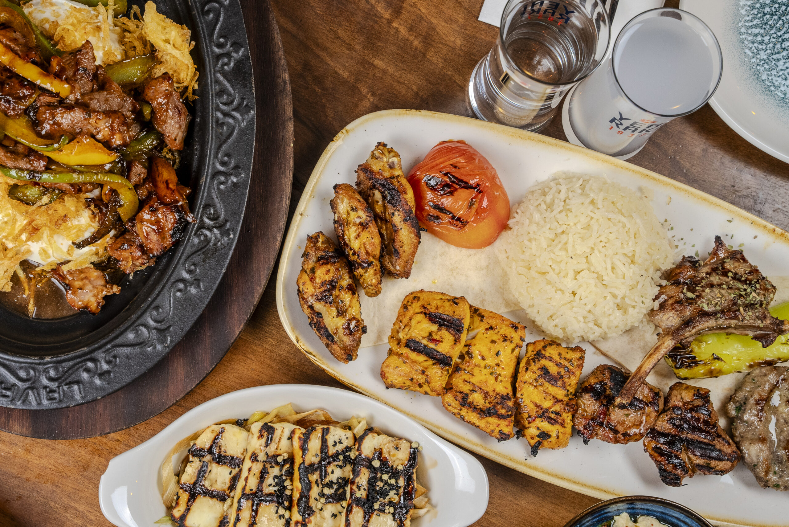 Interior of a Turkish restaurant in Camden with warm lighting, grilled meats, and fresh meze on the table